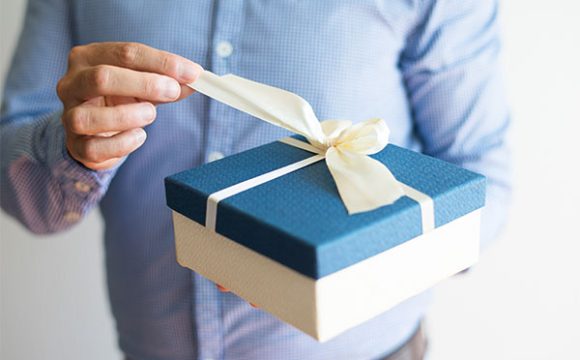 close-up-man-shirt-opening-birthday-gift